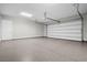 Spacious two car garage featuring epoxy flooring, storage racks, and a door to the house at 9475 W Rosada Way, Las Vegas, NV 89149