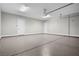 Spacious two car garage featuring epoxy flooring, storage racks, and two doors at 9475 W Rosada Way, Las Vegas, NV 89149