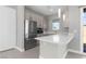 Bright kitchen features stainless steel appliances and a white quartz countertop at 9475 W Rosada Way, Las Vegas, NV 89149