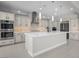 Gourmet kitchen featuring stainless appliances, custom cabinets, and a large center island at 9475 W Rosada Way, Las Vegas, NV 89149