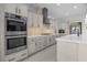 Gourmet kitchen featuring stainless appliances, custom cabinets, and a large center island at 9475 W Rosada Way, Las Vegas, NV 89149