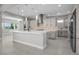 Gourmet kitchen featuring stainless appliances, custom cabinets, and a large center island at 9475 W Rosada Way, Las Vegas, NV 89149