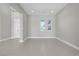 Spacious living room with neutral paint, tile flooring, and plenty of natural light at 9475 W Rosada Way, Las Vegas, NV 89149