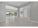 Bright, open living room with tile floors and sliding glass doors to the pool area at 9475 W Rosada Way, Las Vegas, NV 89149