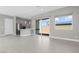Spacious living room adjoining kitchen area with sliding glass doors to backyard at 9475 W Rosada Way, Las Vegas, NV 89149