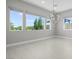 Bright living room with multiple windows offering views of lush greenery and serene outdoor scenery at 9475 W Rosada Way, Las Vegas, NV 89149
