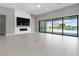 Open living room featuring a modern fireplace and sliding glass doors leading to a pool at 9475 W Rosada Way, Las Vegas, NV 89149