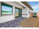 A cozy outdoor patio features gray pavers and a sliding glass door at 9475 W Rosada Way, Las Vegas, NV 89149
