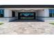 Covered patio boasts stone floors with ceiling fans overlooking the pool area through sliding glass doors at 9475 W Rosada Way, Las Vegas, NV 89149