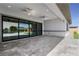 Covered patio boasts stone floors with ceiling fans overlooking the pool area through sliding glass doors at 9475 W Rosada Way, Las Vegas, NV 89149