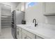 Convenient wet bar with stainless steel refrigerator located near walk-in pantry for easy entertaining at 9475 W Rosada Way, Las Vegas, NV 89149