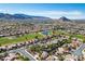 Panoramic aerial view of the community showcasing the golf course, lake, and mountain backdrop at 9524 Quail Ridge Dr, Las Vegas, NV 89134