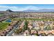 Community aerial view showing lush landscaping, golf course, lakes, and mountain views at 9524 Quail Ridge Dr, Las Vegas, NV 89134