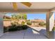 Covered patio overlooking manicured landscaping, hedges, and mature trees offers a peaceful retreat at 9524 Quail Ridge Dr, Las Vegas, NV 89134