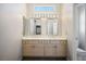Double vanity bathroom with two mirrors, storage cabinets, and a toilet at 9524 Quail Ridge Dr, Las Vegas, NV 89134