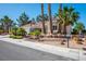 Charming single-story home with a well-manicured front yard and desert landscaping with palm trees at 9524 Quail Ridge Dr, Las Vegas, NV 89134