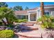 Charming home featuring red brick steps, manicured garden, and desert landscaping in front at 9524 Quail Ridge Dr, Las Vegas, NV 89134