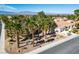 Beautiful aerial view of home featuring lush landscaping, tile roof, and mountain views at 9524 Quail Ridge Dr, Las Vegas, NV 89134