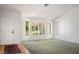 Spacious living room featuring a large window with white shutter, neutral carpet and wood flooring at 9524 Quail Ridge Dr, Las Vegas, NV 89134