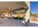 Covered patio with ceiling fan, perfect for outdoor relaxation overlooking the landscaped backyard at 9524 Quail Ridge Dr, Las Vegas, NV 89134