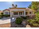 Charming rear exterior with covered patio, manicured landscaping, and neutral color scheme at 9524 Quail Ridge Dr, Las Vegas, NV 89134