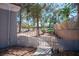 Side yard featuring mature trees, manicured landscaping, and a gated entrance for added privacy at 9524 Quail Ridge Dr, Las Vegas, NV 89134