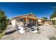 Backyard featuring a covered patio, barbecue area, and low-maintenance landscaping at 100 Eton St, Pahrump, NV 89048