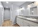 Modern bathroom with dual sinks, granite countertops, and updated lighting fixtures at 100 Eton St, Pahrump, NV 89048