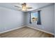 Cozy bedroom with a ceiling fan, bright window with curtains, and wood-look flooring at 100 Eton St, Pahrump, NV 89048
