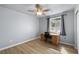 Bright bedroom featuring wood-look flooring, natural light, and a wood desk at 100 Eton St, Pahrump, NV 89048