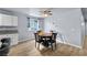 Bright dining room featuring wood flooring, a dining table set and neutral wall colors at 100 Eton St, Pahrump, NV 89048