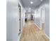 Bright hallway featuring wood-look flooring, leading to various rooms, including the kitchen and bathroom at 100 Eton St, Pahrump, NV 89048