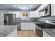 Well-lit kitchen with stainless steel appliances, granite countertops, and white cabinets at 100 Eton St, Pahrump, NV 89048