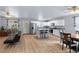 Bright kitchen featuring wood flooring, island with stools and a dining table set at 100 Eton St, Pahrump, NV 89048
