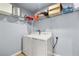 Functional laundry room with a modern washer and dryer set and ample storage shelves at 100 Eton St, Pahrump, NV 89048