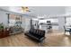Bright living room featuring wood flooring, a modern futon, and a kitchen with island at 100 Eton St, Pahrump, NV 89048