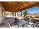 Covered patio with an outdoor dining set, ideal for relaxing or entertaining guests at 100 Eton St, Pahrump, NV 89048