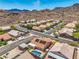 A home with solar panels and a pool, nestled in a desert community with a stunning mountain view backdrop at 1044 Spanish Needle St, Henderson, NV 89002