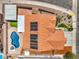 Aerial view of a home featuring a private backyard pool, solar panels, and lush artificial turf at 1044 Spanish Needle St, Henderson, NV 89002