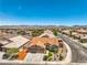 Aerial view of a charming home featuring a tile roof in a vibrant neighborhood surrounded by mountains at 1044 Spanish Needle St, Henderson, NV 89002