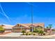 Attractive home with desert landscaping, a three-car garage, and a tile roof at 1044 Spanish Needle St, Henderson, NV 89002