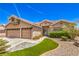 Inviting home with a well-manicured lawn and a spacious three-car garage at 1044 Spanish Needle St, Henderson, NV 89002