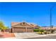 Charming single-story home featuring a three-car garage and desert landscaping at 1044 Spanish Needle St, Henderson, NV 89002