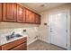 Laundry room featuring cabinets, sink, countertops, and a door at 1044 Spanish Needle St, Henderson, NV 89002