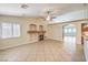 Open-concept living room with tile floors, fireplace, and archways to the kitchen at 1044 Spanish Needle St, Henderson, NV 89002