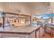 Beautiful outdoor kitchen under a covered patio with a view of the yard with sparkling pool at 1044 Spanish Needle St, Henderson, NV 89002