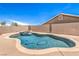 Beautiful pool and jacuzzi area in backyard with clear blue skies and well-maintained landscaping at 1044 Spanish Needle St, Henderson, NV 89002