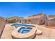 Inviting pool with a spa and lush backyard featuring a covered patio for relaxing in the sun at 1044 Spanish Needle St, Henderson, NV 89002