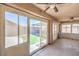 Bright sun room with ceiling fans and sliding glass doors to the beautiful green backyard and patio at 1044 Spanish Needle St, Henderson, NV 89002