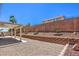 Spacious backyard features a covered patio and low-maintenance desert landscaping at 1073 Nordyke Ave, Henderson, NV 89015
